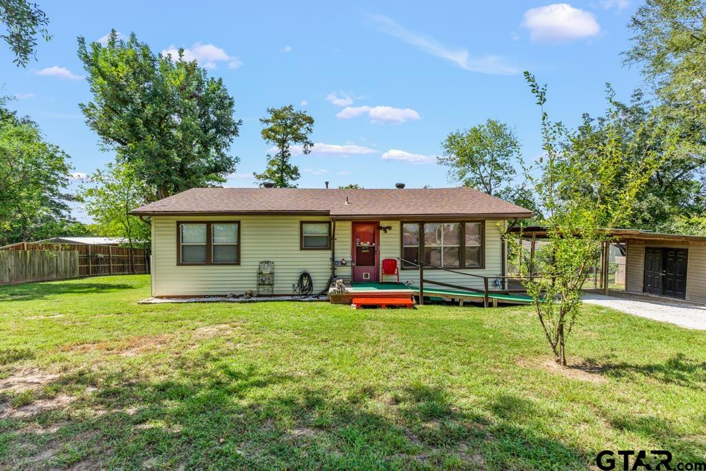 a view of a house with pool and a yard