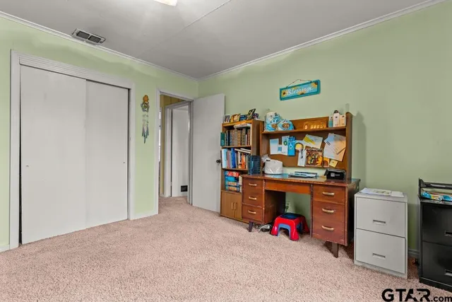 a view of a bedroom with workspace and natural light
