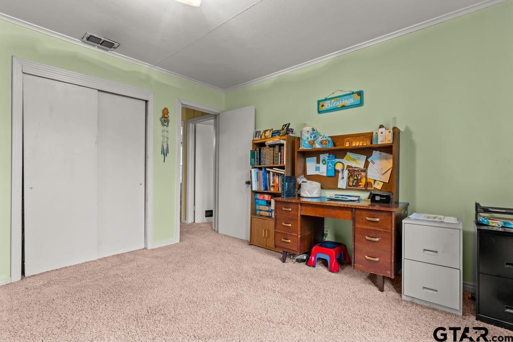 2131 Tryon Road Longview, TX 75601 - Photo 12 of 39 a view of a bedroom with workspace and natural light