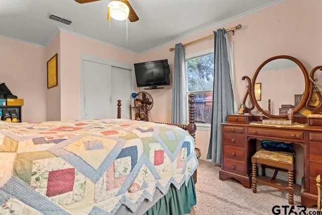 a bedroom with a bed and a flat screen tv