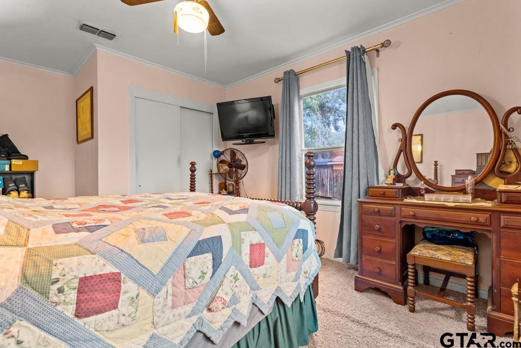 2131 Tryon Road Longview, TX 75601 - Photo 18 of 39 a bedroom with a bed and a flat screen tv