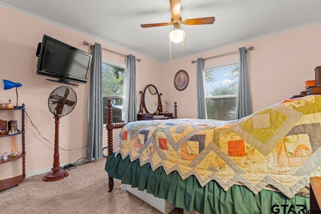 2131 Tryon Road Longview, TX 75601 - Photo 19 of 39 a bedroom with a bed a flat screen tv and a window