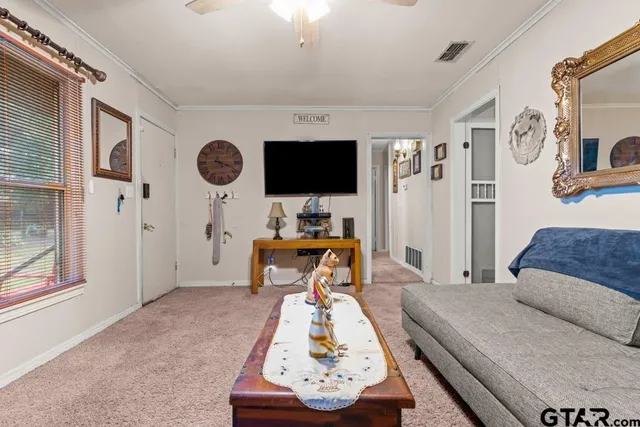 a living room with furniture and a flat screen tv