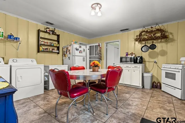 a dining room with furniture and wooden floor