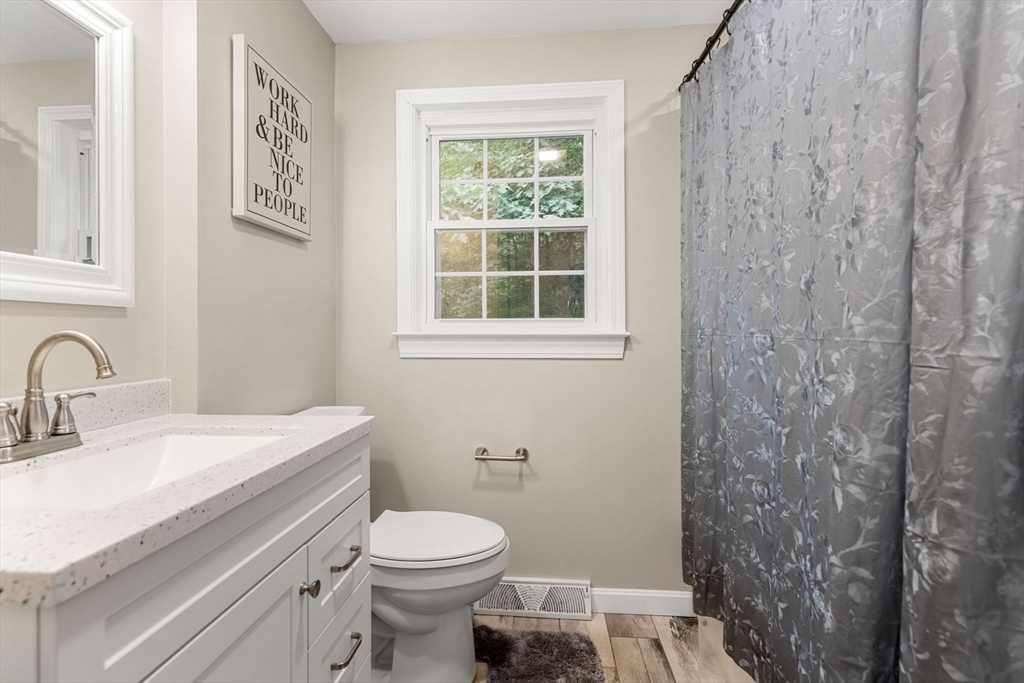 25 Holly Drive Gardner, MA 01440 - Photo 26 of 32 a bathroom with a sink a toilet and a window