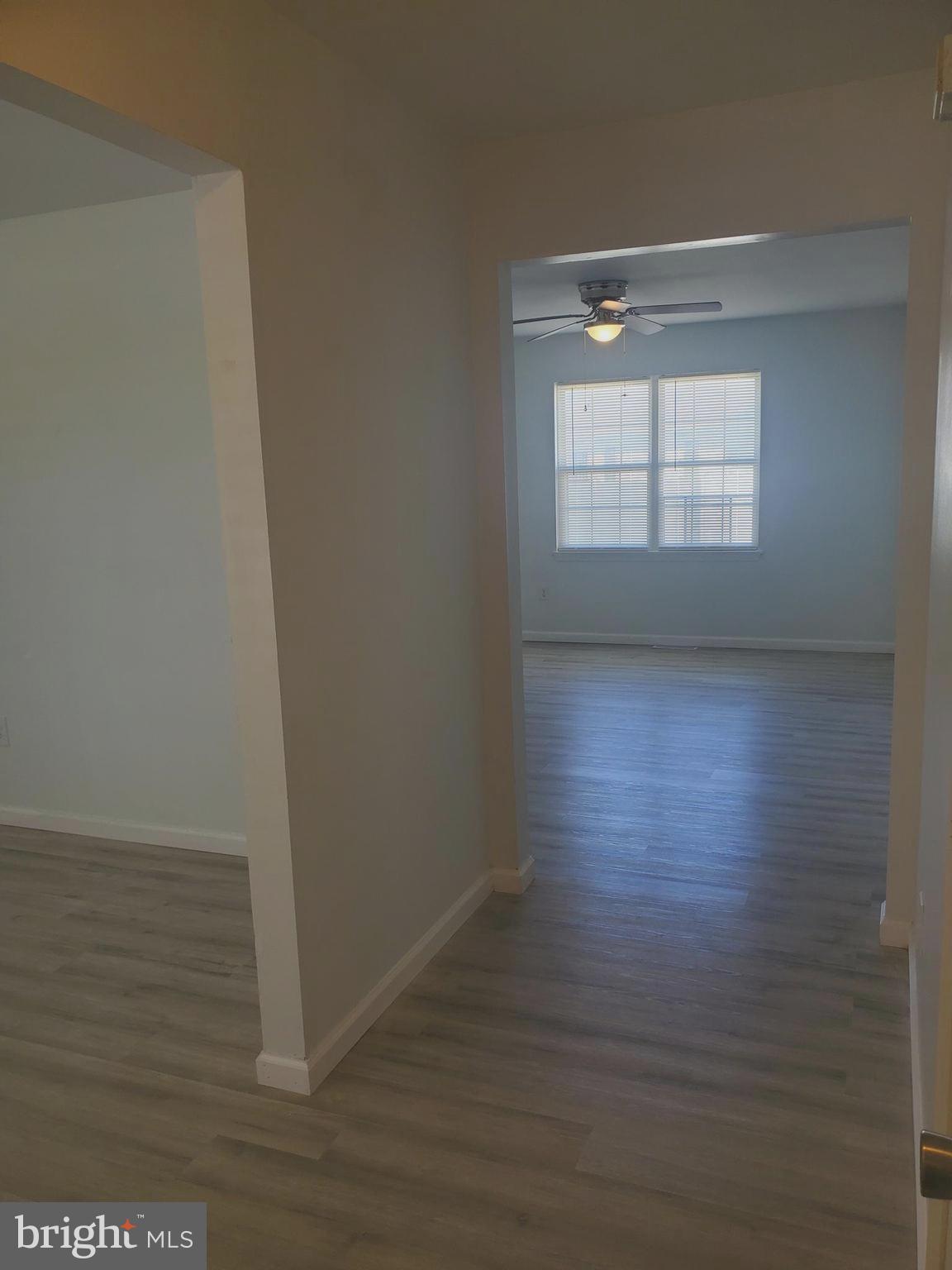 112 Holmes Street Dover, DE 19901 - Photo 14 of 24 a view of an empty room with wooden floor and a window