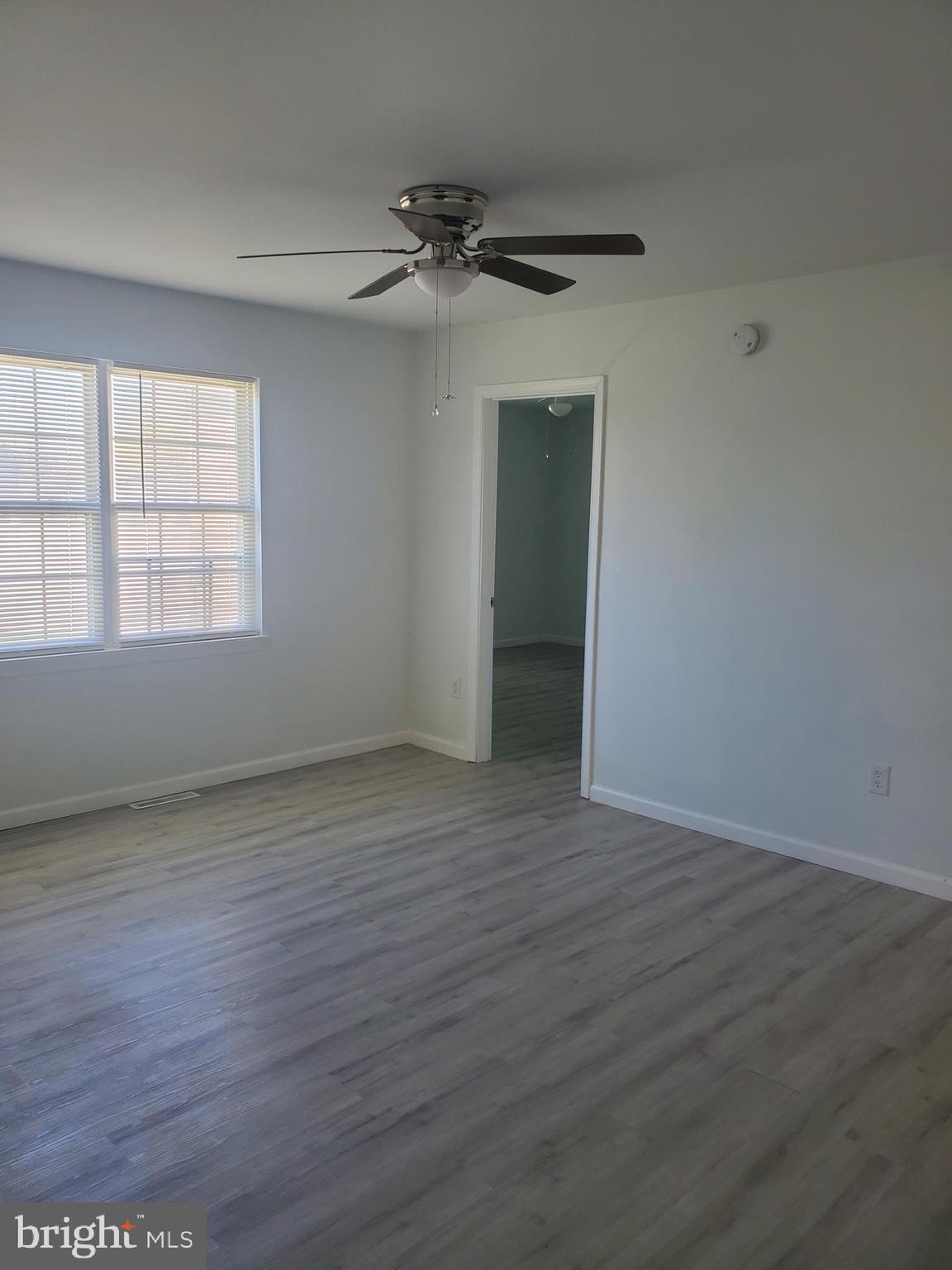 112 Holmes Street Dover, DE 19901 - Photo 15 of 24 wooden floor in an empty room with a window