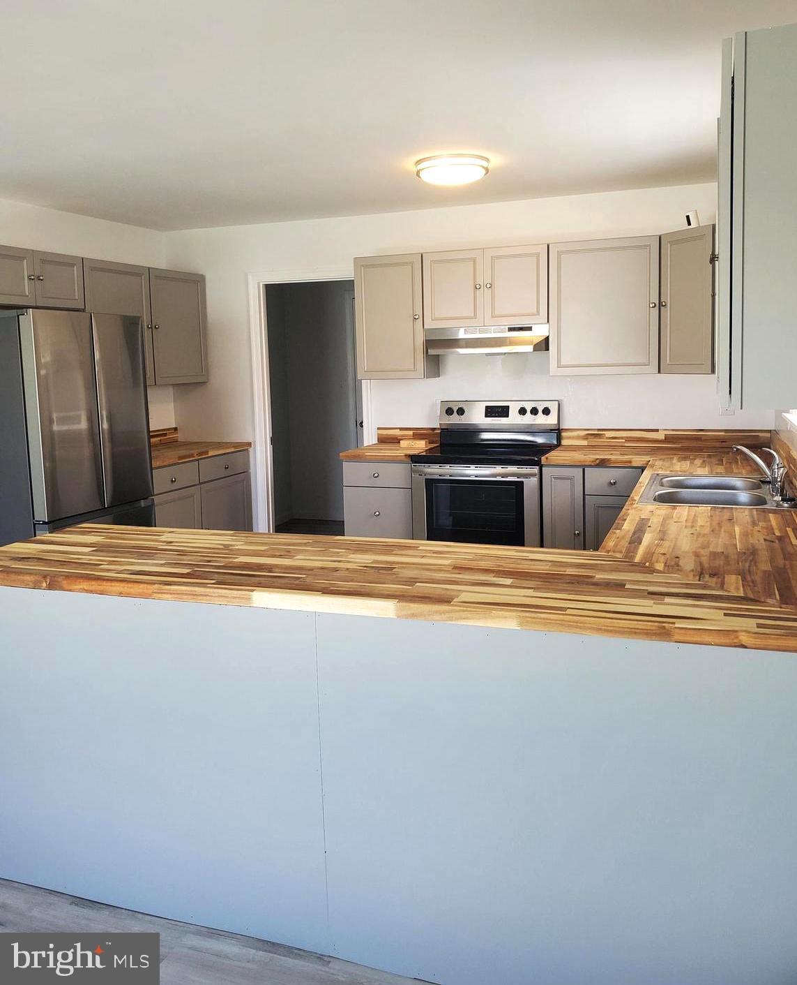 112 Holmes Street Dover, DE 19901 - Photo 20 of 24 a kitchen with stainless steel appliances granite countertop a refrigerator a sink and a stove