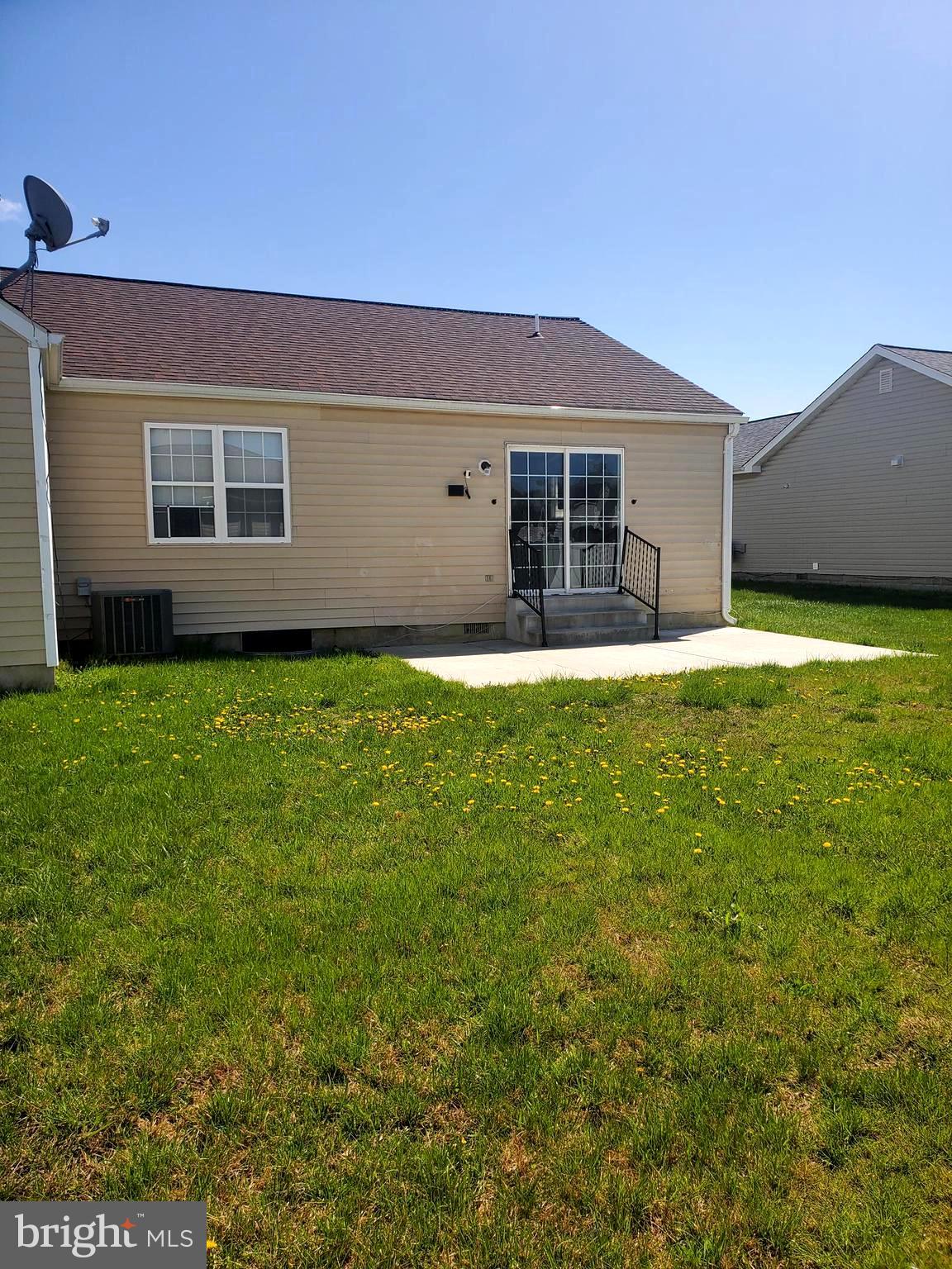112 Holmes Street Dover, DE 19901 - Photo 23 of 24 a backyard of a house with yard and outdoor seating