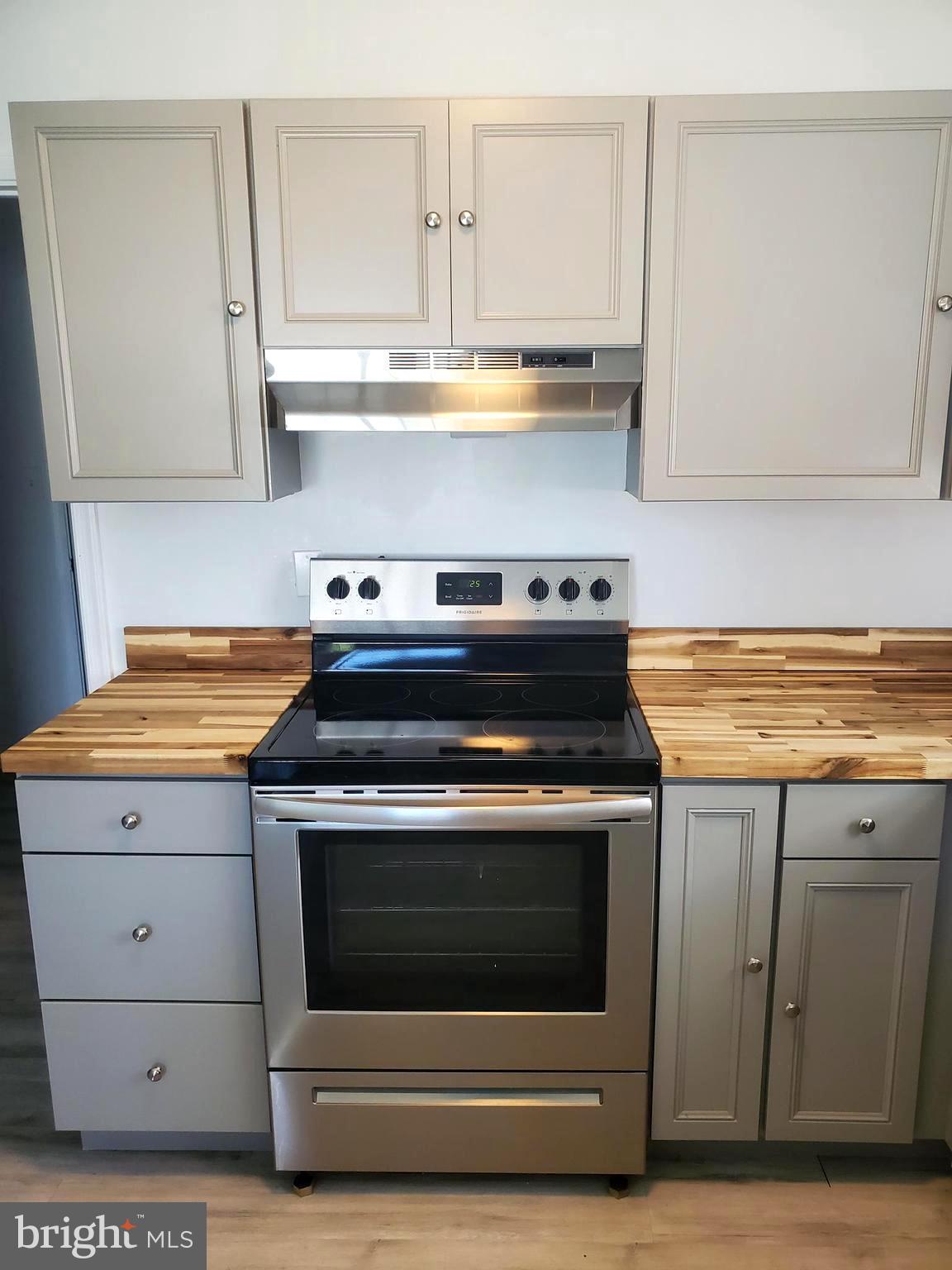 112 Holmes Street Dover, DE 19901 - Photo 6 of 24 a stove top oven sitting inside of a kitchen