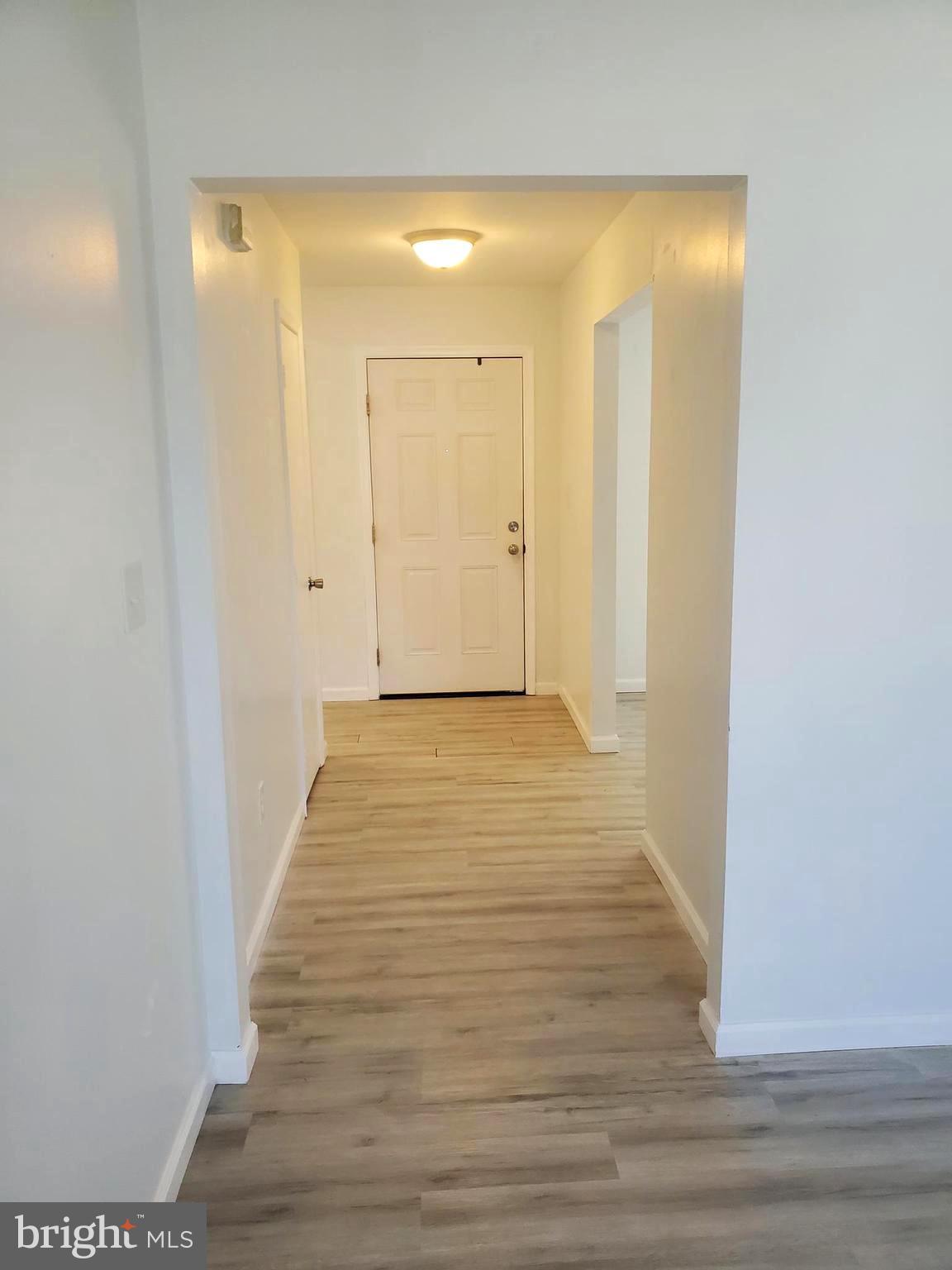 112 Holmes Street Dover, DE 19901 - Photo 8 of 24 a view of a hallway with wooden floor