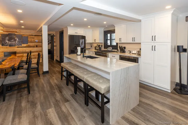 a large kitchen with a table and chairs