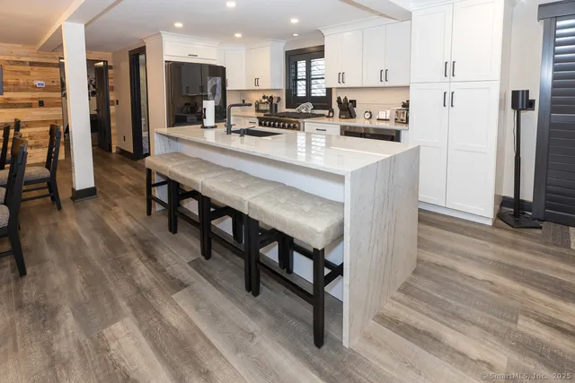 a kitchen with stainless steel appliances granite countertop a stove and a refrigerator