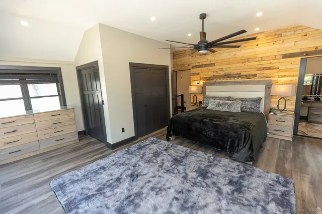 a spacious bathroom with a granite countertop sink and a large window