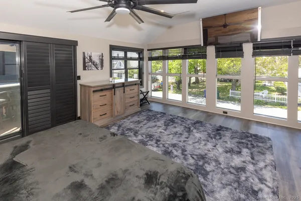 a living room with a bed furniture and a large window