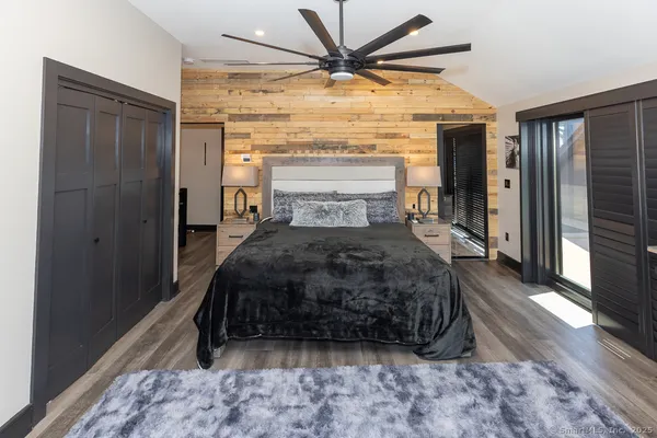 a bathroom with a granite countertop sink toilet and mirror