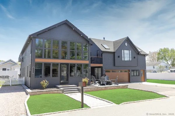 a front view of a house with garden and porch