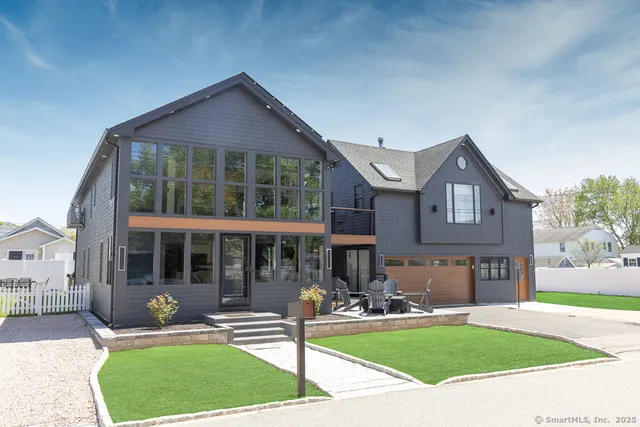 a front view of a house with garden and porch