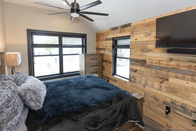 an outdoor sitting area with furniture and wooden floor