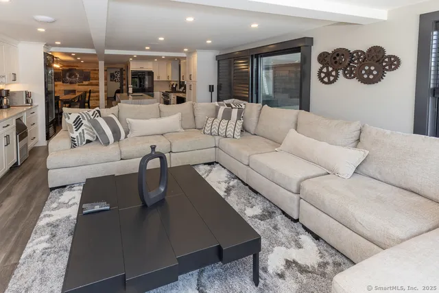a living room with furniture and kitchen view