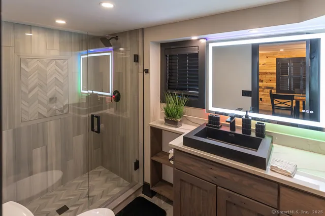 a bathroom with a shower and a sink