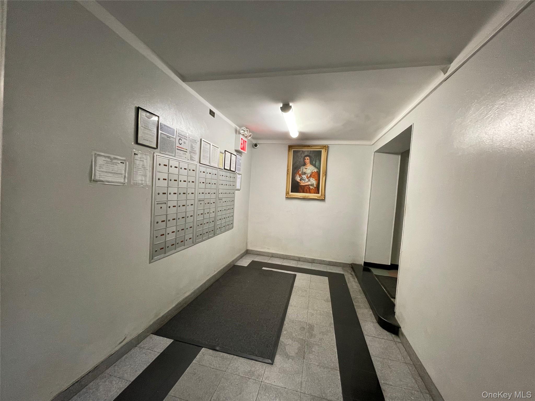 63-60 102nd Street, Unit D7 Queens, NY 11374 - Photo 20 of 41 Corridor with mail area, inlaid floor details, and light tile patterned floors