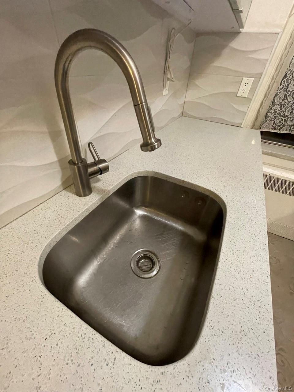 63-60 102nd Street, Unit D7 Queens, NY 11374 - Photo 28 of 41 Kitchen view of light stone countertops and backsplash