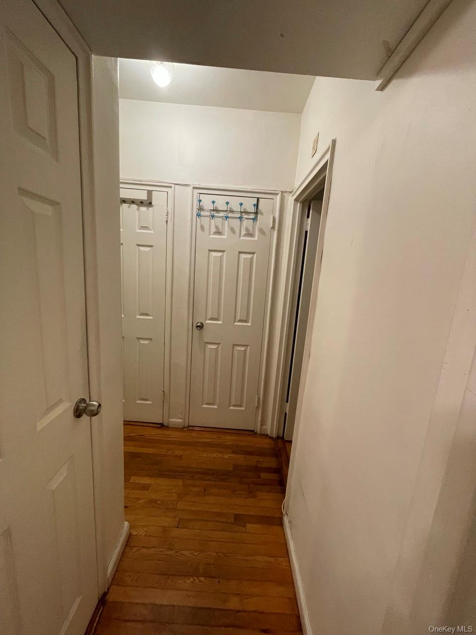 63-60 102nd Street, Unit D7 Queens, NY 11374 - Photo 32 of 41 Corridor with dark wood-style floors and baseboards