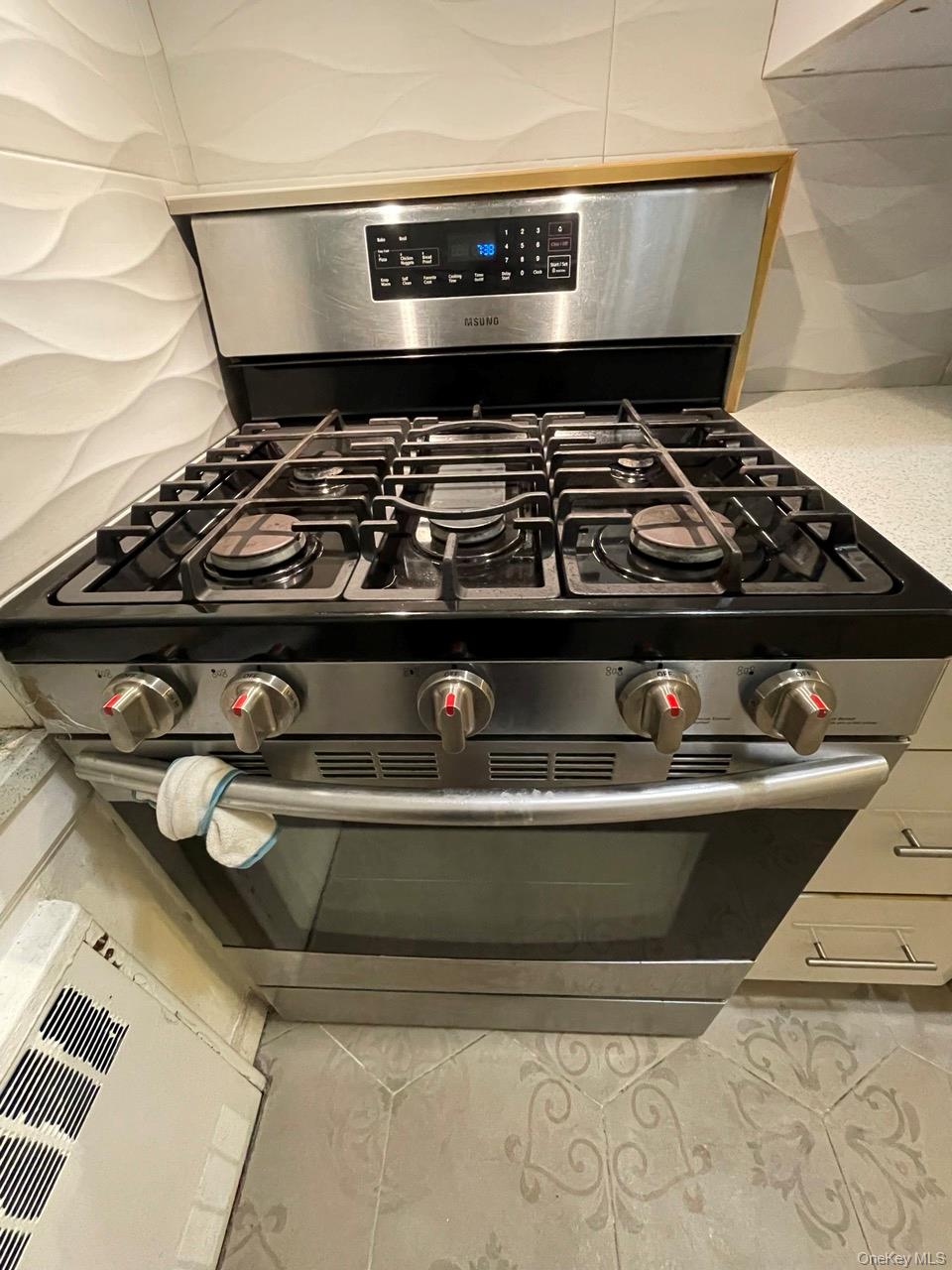 63-60 102nd Street, Unit D7 Queens, NY 11374 - Photo 36 of 41 Kitchen view of stainless steel gas stove and light countertops