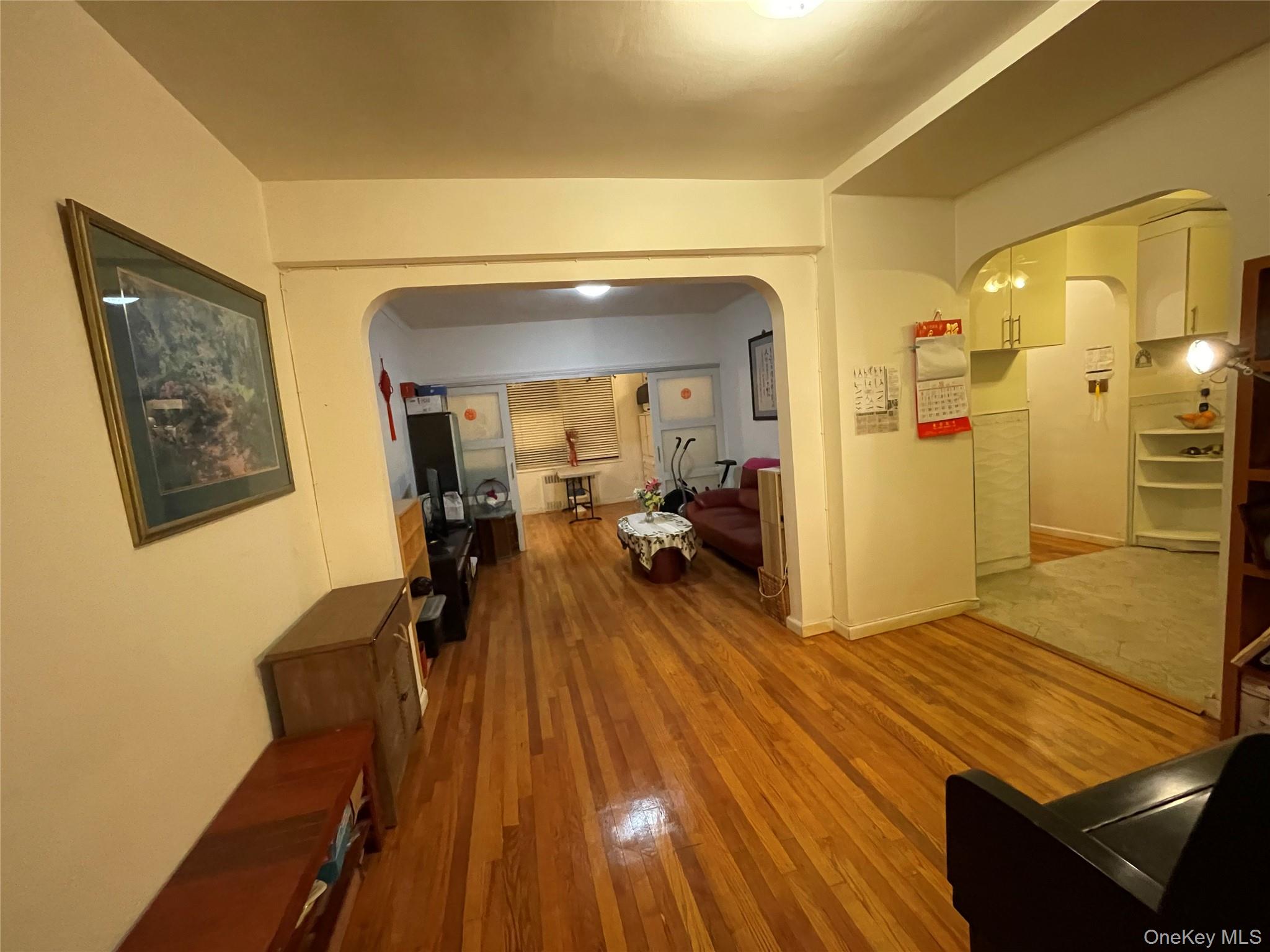 63-60 102nd Street, Unit D7 Queens, NY 11374 - Photo 7 of 41 Corridor with arched walkways and light wood-type flooring