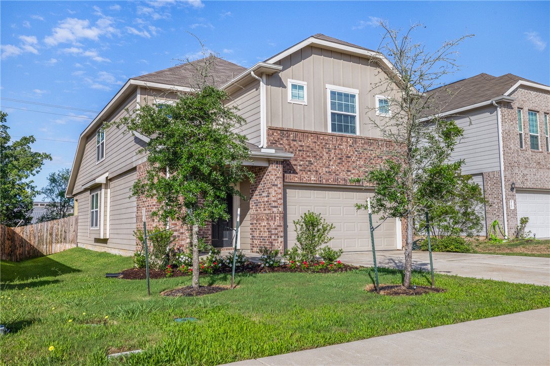 4702 Nopalitos Way Bryan, TX 77807 - Photo 2 of 27 a front view of a house with a yard and garage