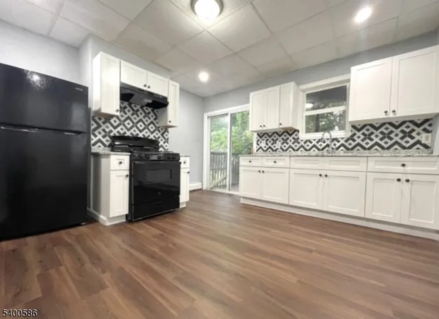 a kitchen with stainless steel appliances a refrigerator and a stove top oven