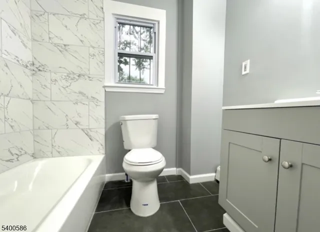 a bathroom with a sink a toilet and bathtub