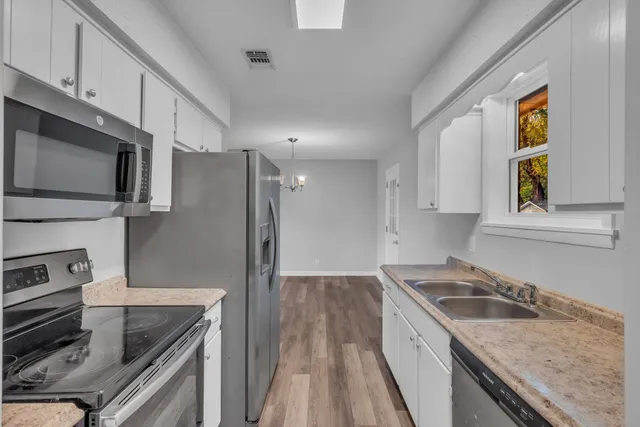 a kitchen with a sink stove and microwave