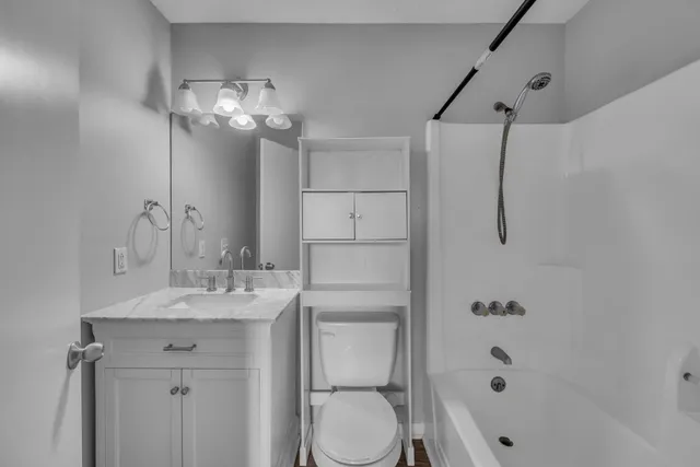 a bathroom with a sink toilet a mirror and shower