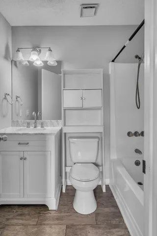 a bathroom with a toilet sink and shower