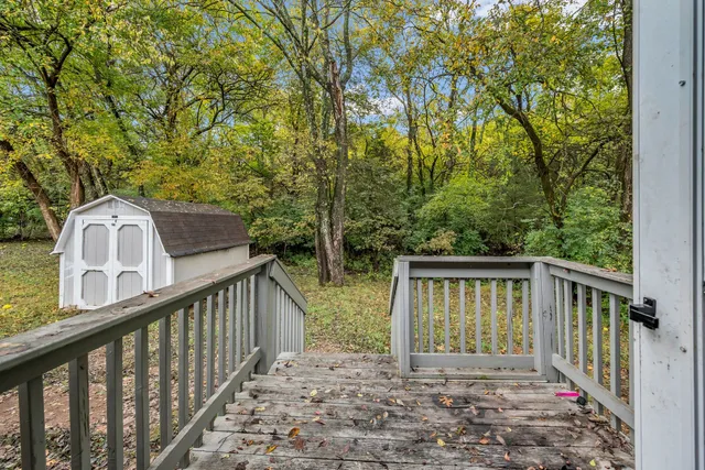 a view of house with backyard and trees