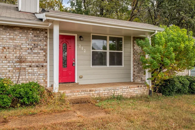 a view of a house with a small yard and plants