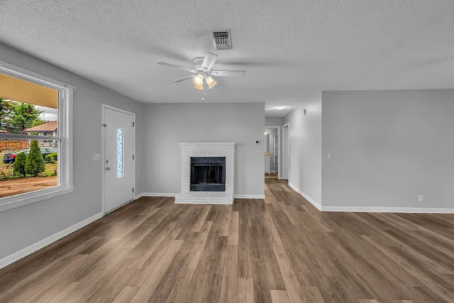 wooden floor in an empty room with a fireplace