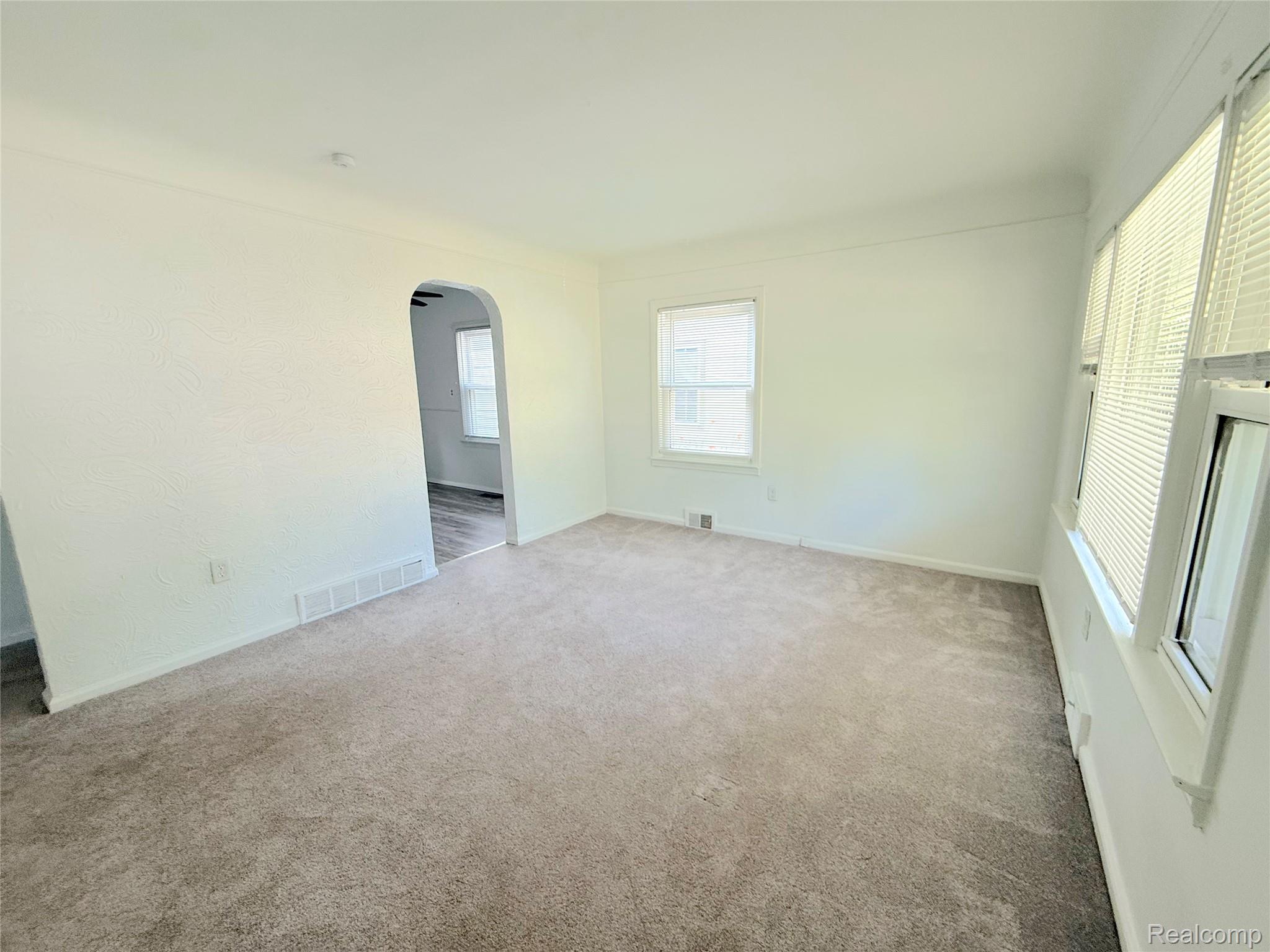 21212 Rensselaer Street Farmington, MI 48336 - Photo 3 of 11 Spacious interior room with neutral-toned carpeting and white walls