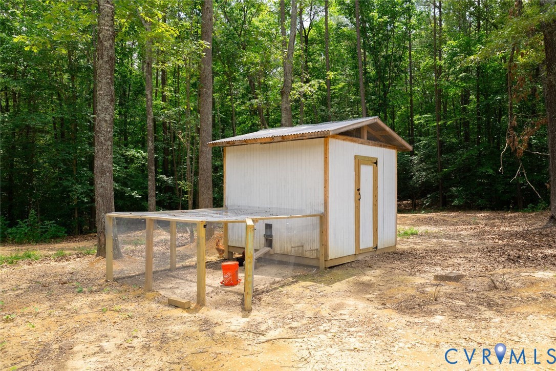 12397 New Market Mill Road Beaverdam, VA 23015 - Photo 41 of 44 a view of backyard with large trees and wooden fence