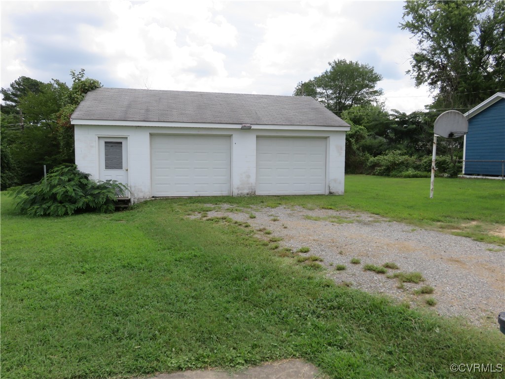9809 Durango Road Henrico, VA 23228 - Photo 17 of 19 a front view of a house with a yard and garage