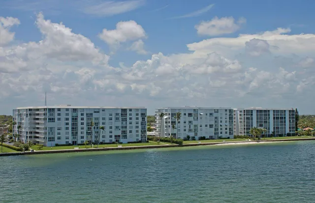 a view of water with tall building in the background