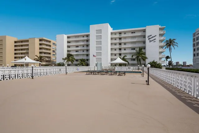 a view of building with yard and parking
