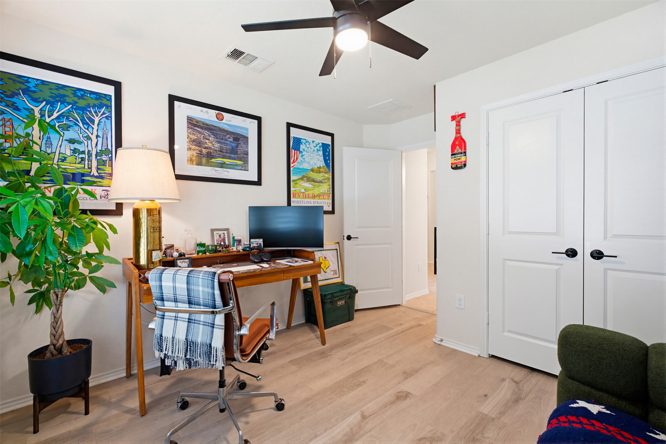 5705 Southerner Way Austin, TX 78747 - Photo 7 of 22 Bright and airy home office with natural wood-look flooring and ample space for productivity.