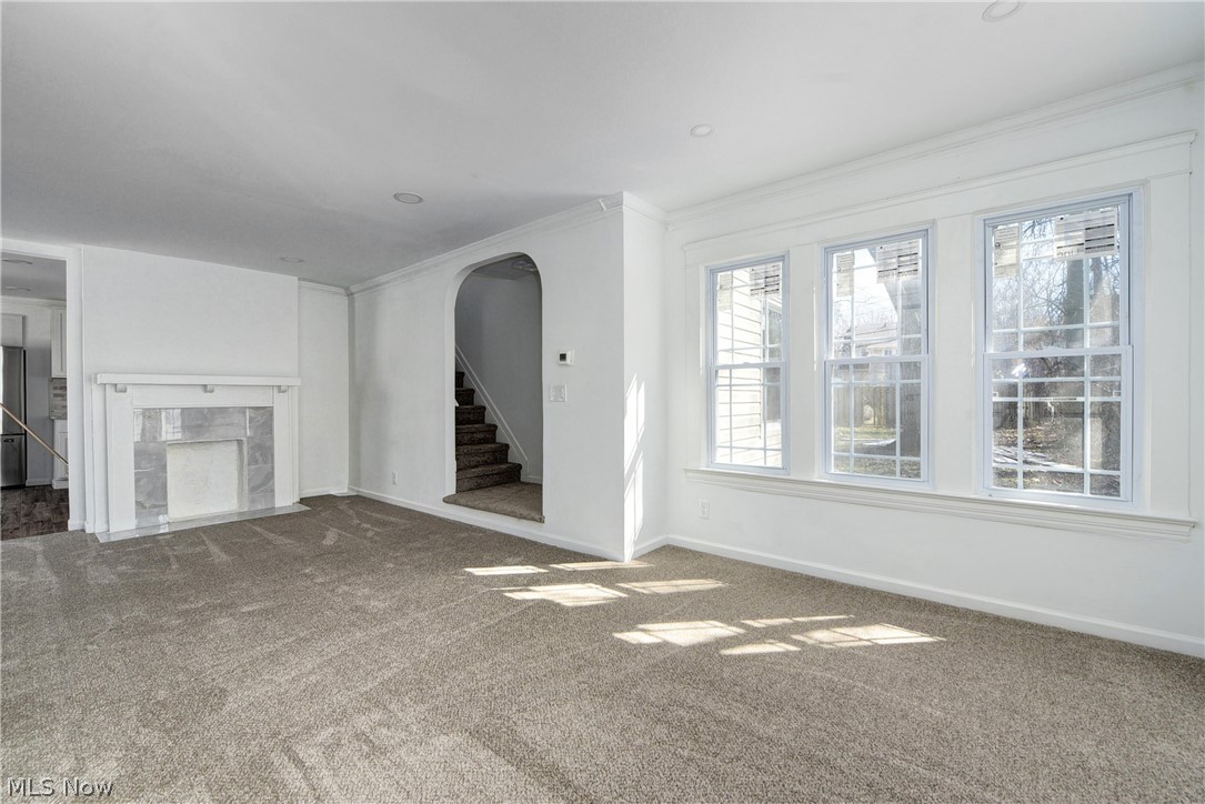 3164 Whitethorn Road Cleveland, OH 44118 - Photo 9 of 31 Unfurnished living room featuring crown molding and dark carpet