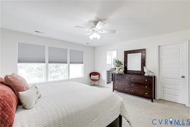 a bathroom with a granite countertop sink a toilet and shower