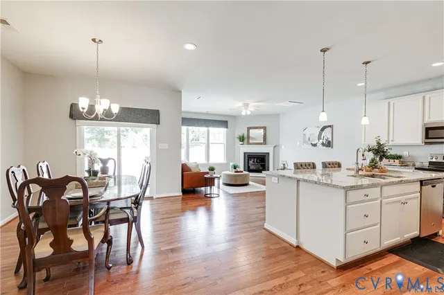 a large kitchen with a counter space a dining table and chairs