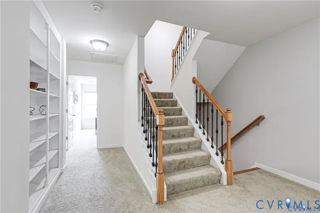 a living room with lots of furniture and kitchen view