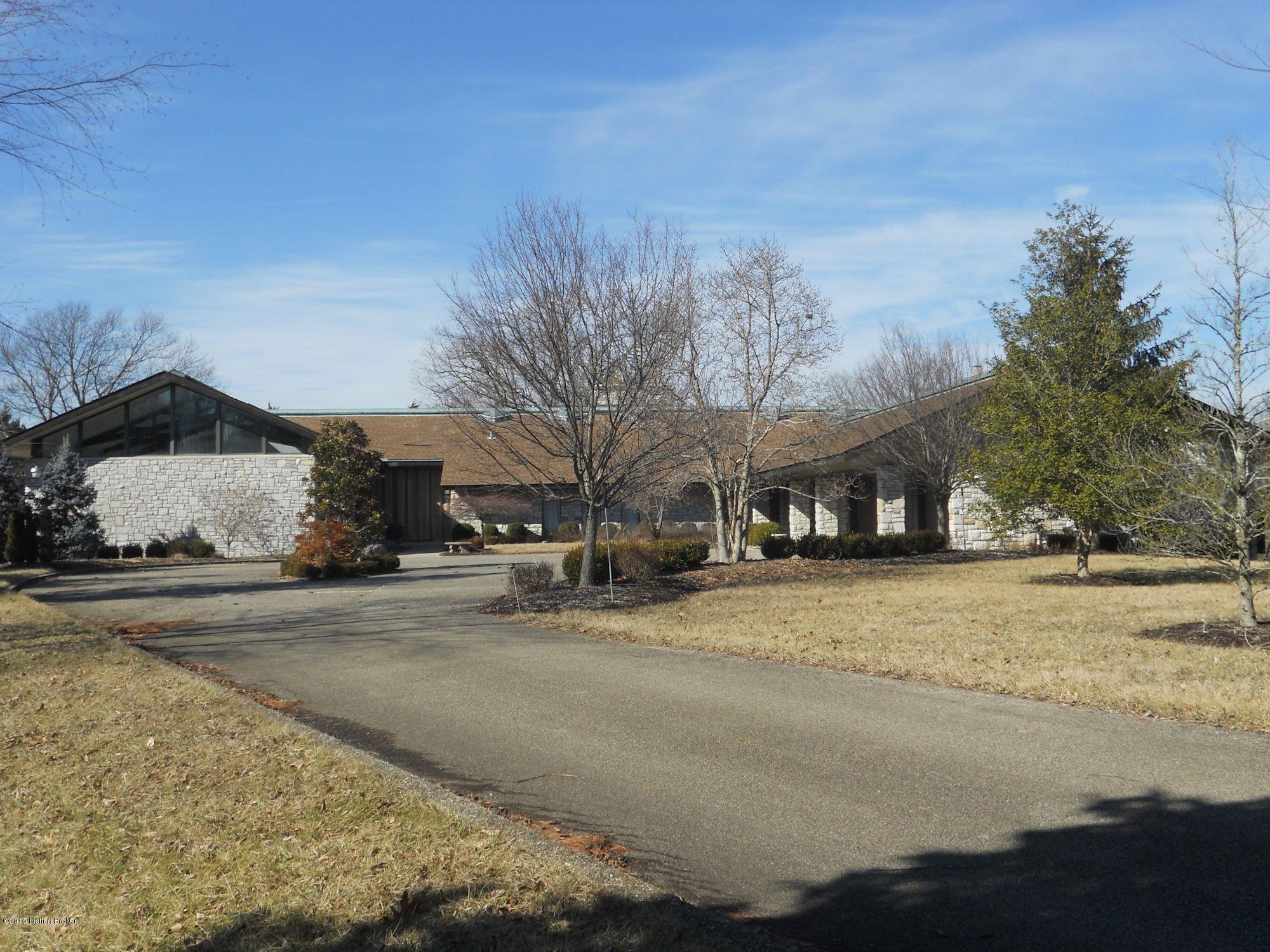 Concrete Driveway leads back to this Unique Stone Home on 105 acres.